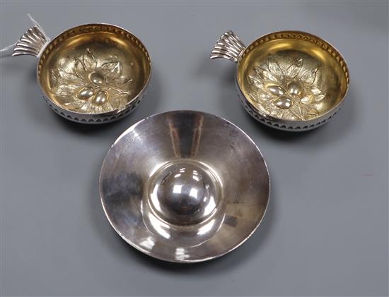 A pair of continental white metal taste vin, with gilt interior, embossed with berries and a plated taste vin?, taste vin 10cm.